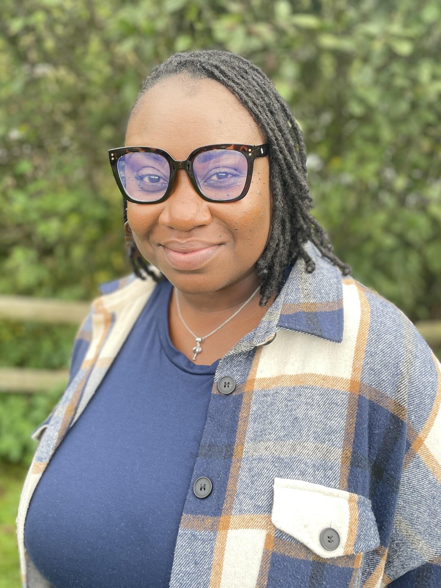 Admissions Coordinator Ashea Green smiling in front of greenery